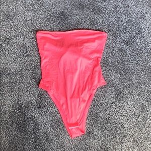 Neon pink body suit